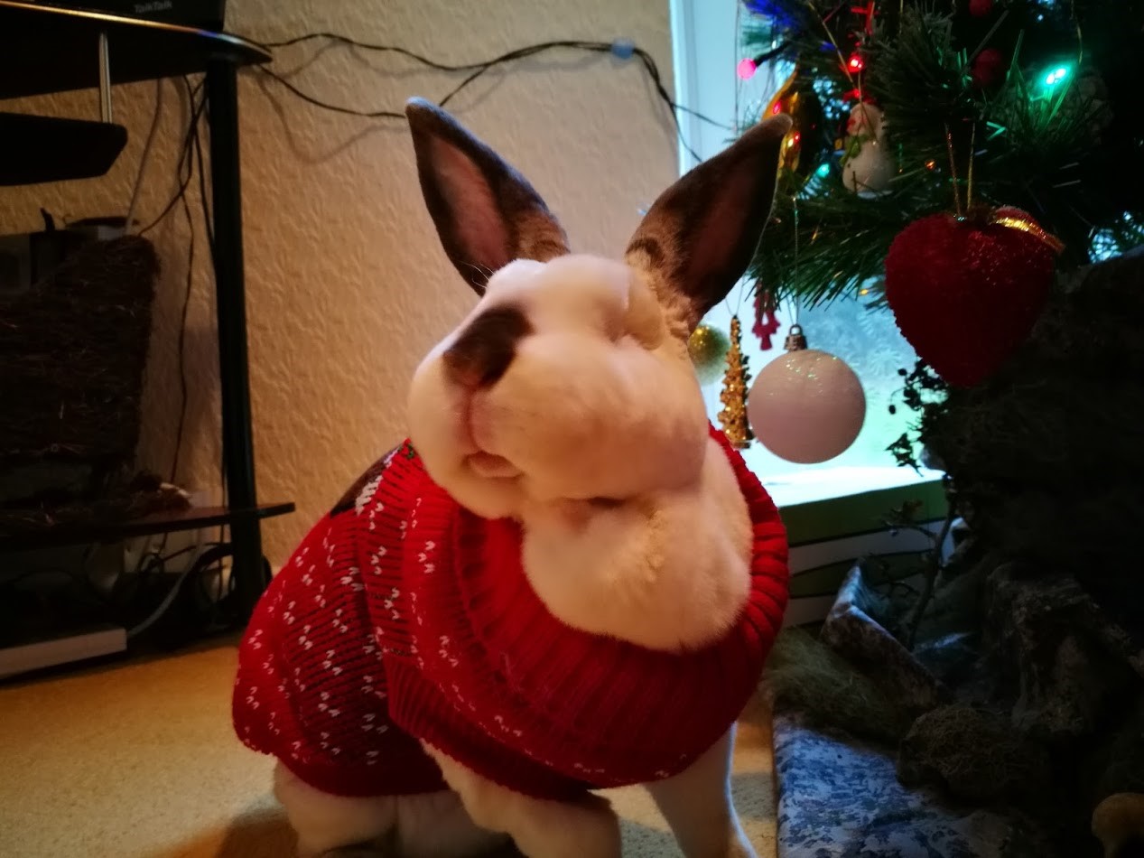 Cute bunny beside Christmas tree